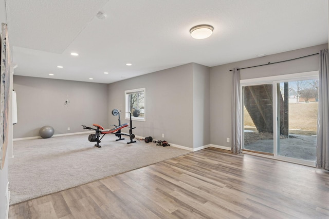 exercise room with recessed lighting, baseboards, and wood finished floors