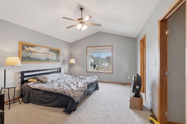 bedroom featuring baseboards, ceiling fan, vaulted ceiling, carpet floors, and a textured ceiling