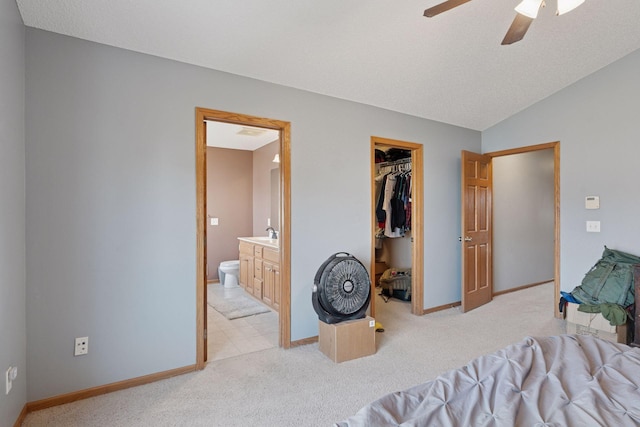 bedroom with baseboards, lofted ceiling, and light colored carpet