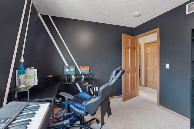 office area featuring visible vents, a textured ceiling, baseboards, and carpet floors