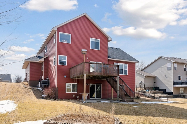 back of house with stairway, a yard, a wooden deck, and a shingled roof