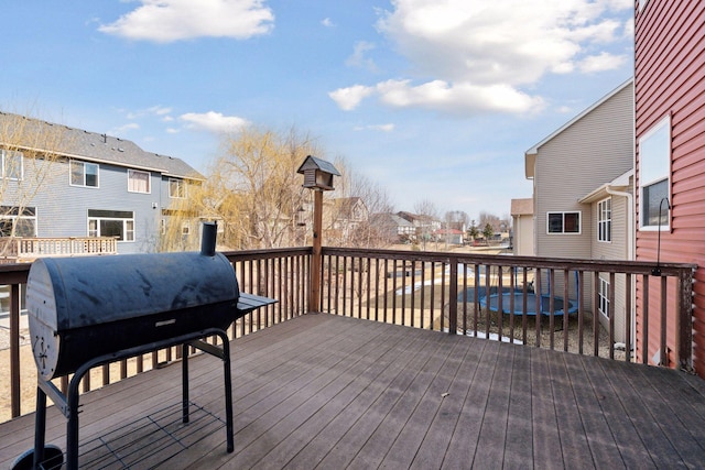 wooden terrace with area for grilling and a residential view