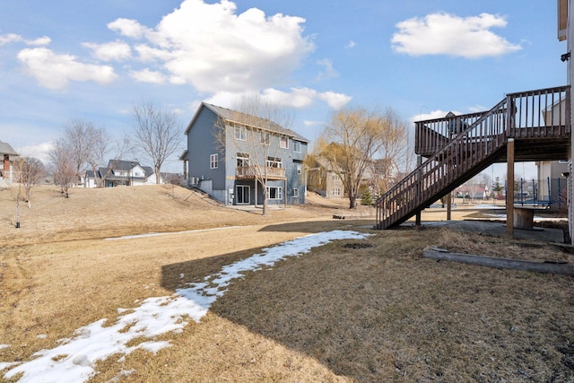 view of yard featuring a wooden deck and stairs