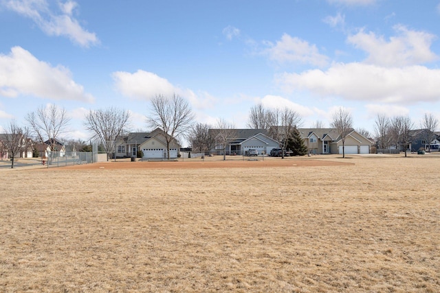 view of yard with a residential view and fence