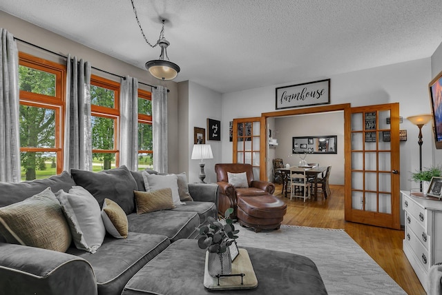 living room with wood finished floors and a textured ceiling