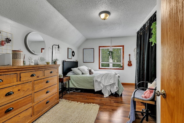 bedroom featuring a textured ceiling, baseboards, dark wood-type flooring, and vaulted ceiling