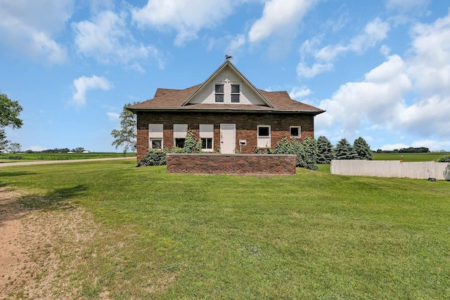 rear view of property with brick siding and a lawn