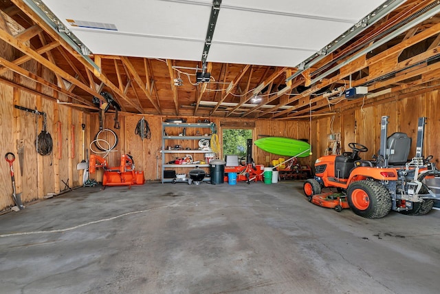 garage featuring a garage door opener and wood walls