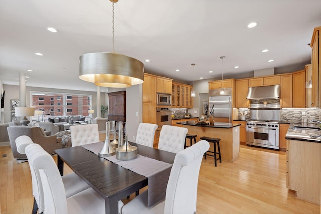 dining area with recessed lighting and light wood-type flooring