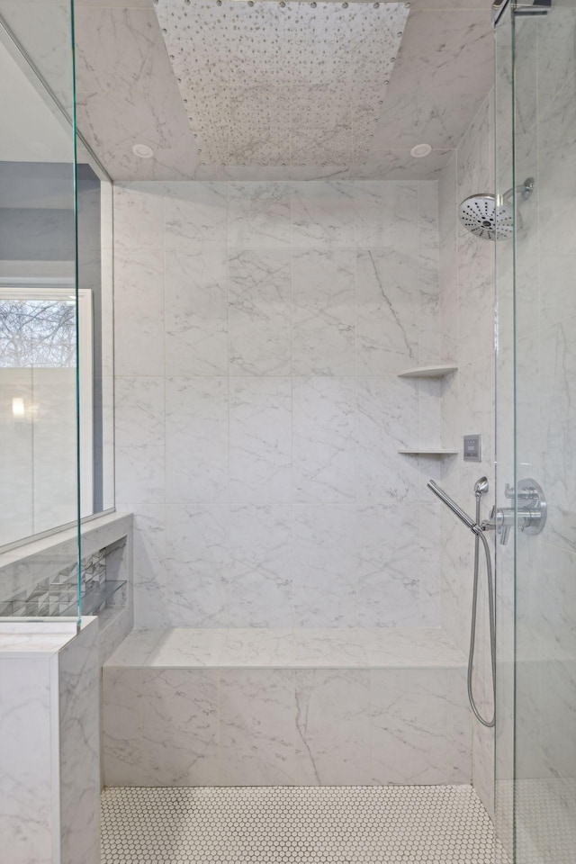 full bath featuring a marble finish shower