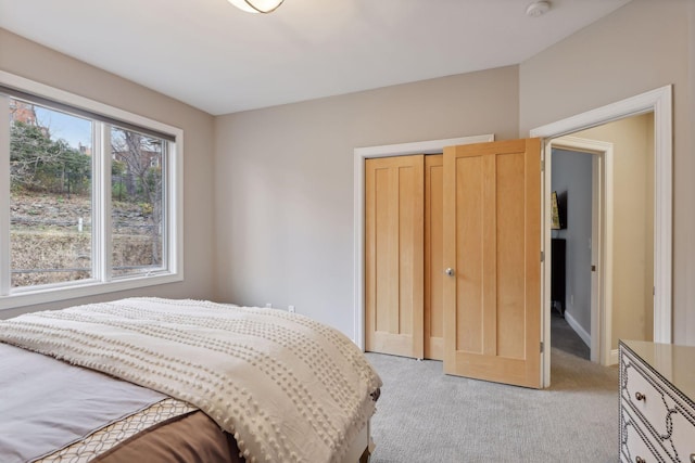 bedroom with a closet and light carpet