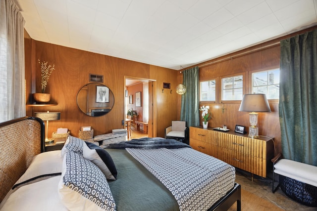 bedroom featuring wood walls