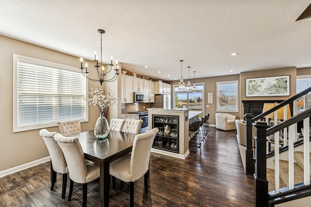 dining room featuring an inviting chandelier, dark wood-style floors, and stairs