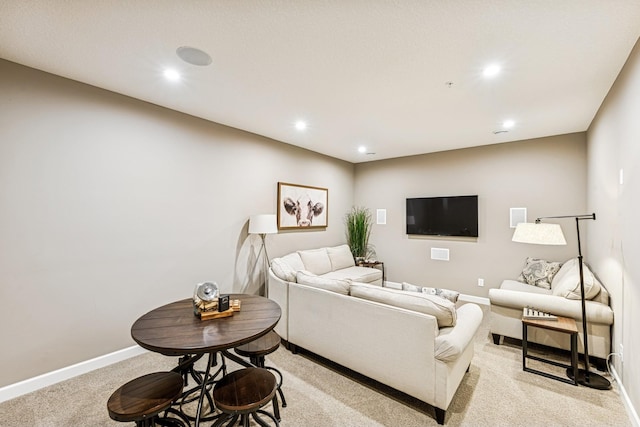 living area with recessed lighting, light colored carpet, and baseboards