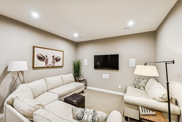 carpeted living area featuring recessed lighting and baseboards