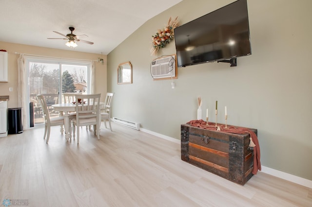 dining area with light wood-style floors, baseboards, and a baseboard radiator