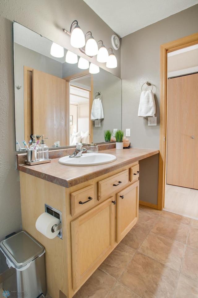 bathroom with tile patterned floors and vanity