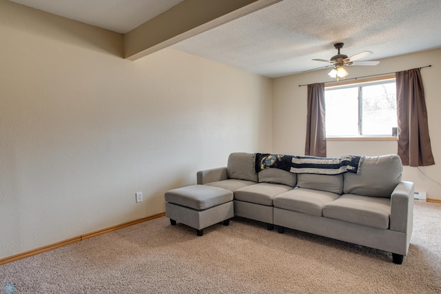 living area with baseboard heating, a textured ceiling, baseboards, light colored carpet, and ceiling fan