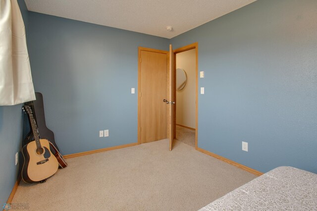 carpeted bedroom with baseboards