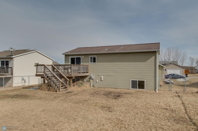 rear view of house featuring a gate, stairs, a deck, and fence