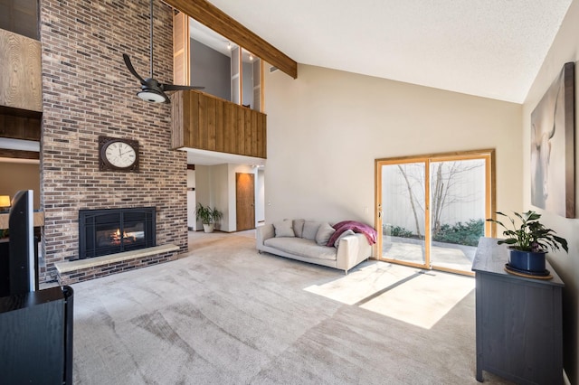 carpeted living room featuring a textured ceiling, beamed ceiling, a fireplace, and high vaulted ceiling