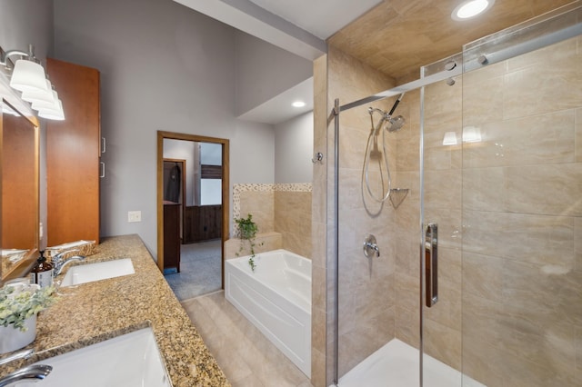 bathroom with a stall shower, a sink, recessed lighting, double vanity, and a bath