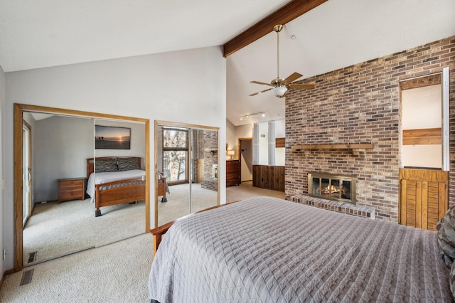 bedroom with carpet, visible vents, high vaulted ceiling, beam ceiling, and a brick fireplace