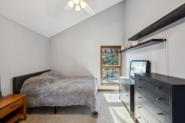 bedroom with light carpet, a ceiling fan, and vaulted ceiling