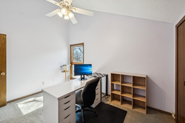 office featuring baseboards, carpet, ceiling fan, and a textured ceiling