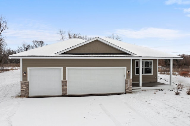 view of front of property with a garage and stone siding