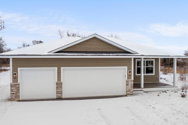 view of front of house with a garage and stone siding