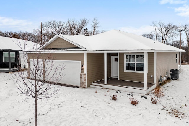 view of front of home featuring a garage, central AC unit, and a porch