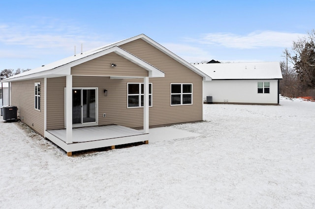 rear view of property featuring cooling unit and a deck