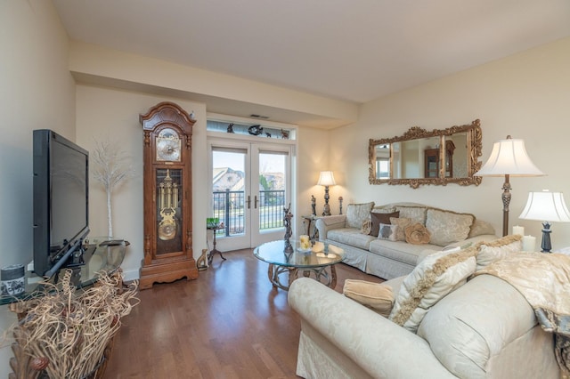 living area featuring wood finished floors, french doors, and visible vents