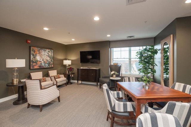 living room with recessed lighting, light colored carpet, and baseboards