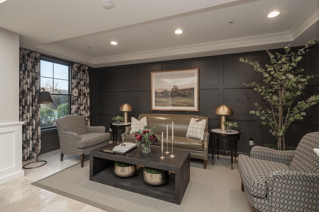 living area featuring a decorative wall, recessed lighting, and ornamental molding