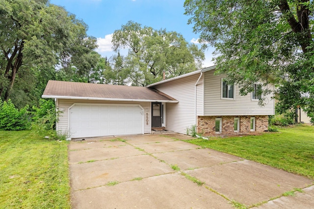 tri-level home featuring brick siding, a garage, concrete driveway, and a front lawn