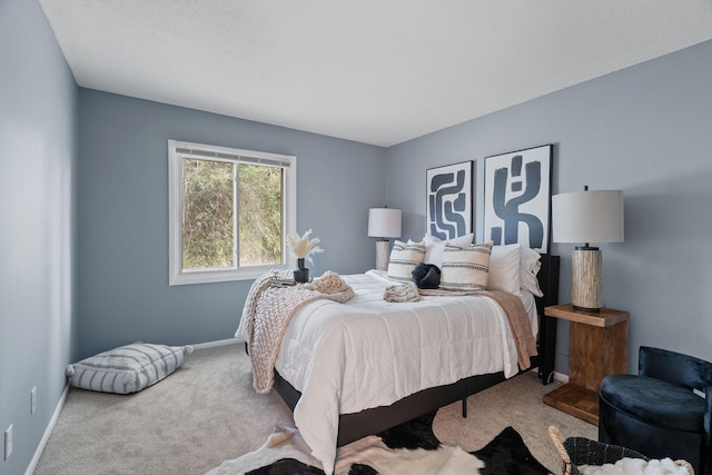 bedroom featuring baseboards and carpet floors