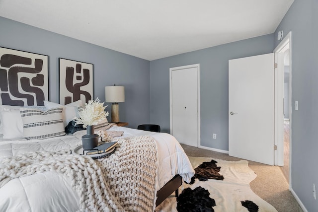 bedroom featuring carpet and baseboards