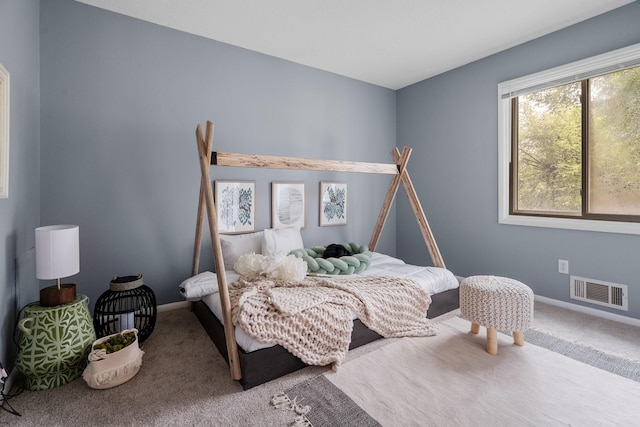 bedroom with visible vents, carpet floors, and baseboards