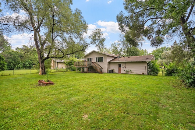 view of yard featuring central air condition unit, a deck, stairs, and fence