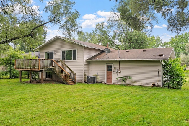 back of house featuring stairs, a deck, a yard, and central AC unit