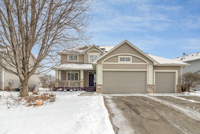 view of front facade with a garage, a porch, and driveway