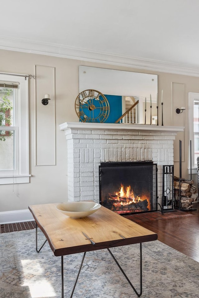 5026 Nokomis Ave, Minneapolis, MN 55417 - living room featuring a brick fireplace, wood finished floors, crown molding, and baseboards