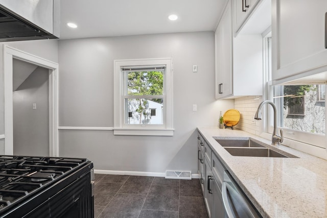 5026 Nokomis Ave, Minneapolis, MN 55417 - kitchen with a sink, light stone counters, baseboards, backsplash, and dishwasher