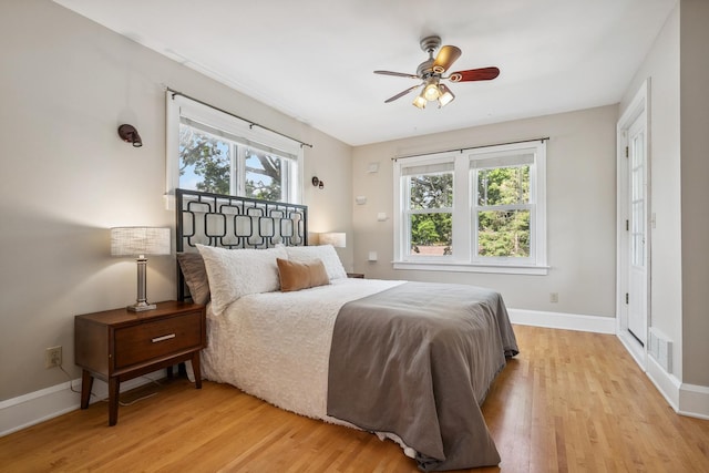 5026 Nokomis Ave, Minneapolis, MN 55417 - bedroom featuring multiple windows, light wood finished floors, and baseboards