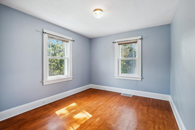 5026 Nokomis Ave, Minneapolis, MN 55417 - empty room featuring plenty of natural light, baseboards, and wood finished floors