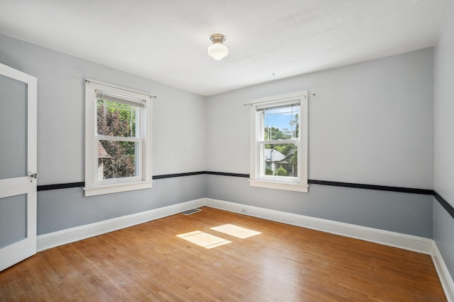 5026 Nokomis Ave, Minneapolis, MN 55417 - empty room featuring healthy amount of natural light, wood finished floors, and baseboards