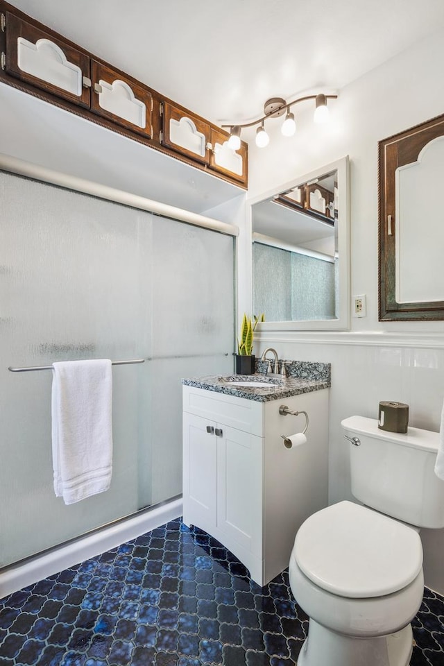 5026 Nokomis Ave, Minneapolis, MN 55417 - bathroom featuring vanity, a shower with shower door, a wainscoted wall, and toilet