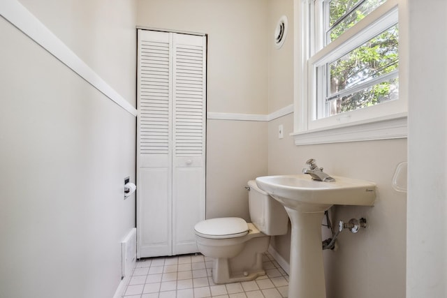 5026 Nokomis Ave, Minneapolis, MN 55417 - bathroom featuring a closet, toilet, tile patterned floors, and healthy amount of natural light